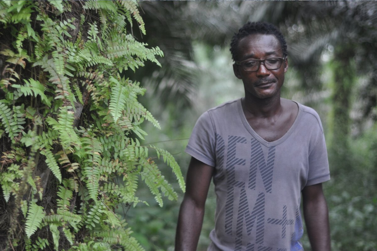 Man from Cameroon village in palm oil plantation